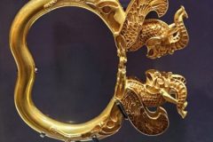 Gold armlet with leaping lion and griffin.
